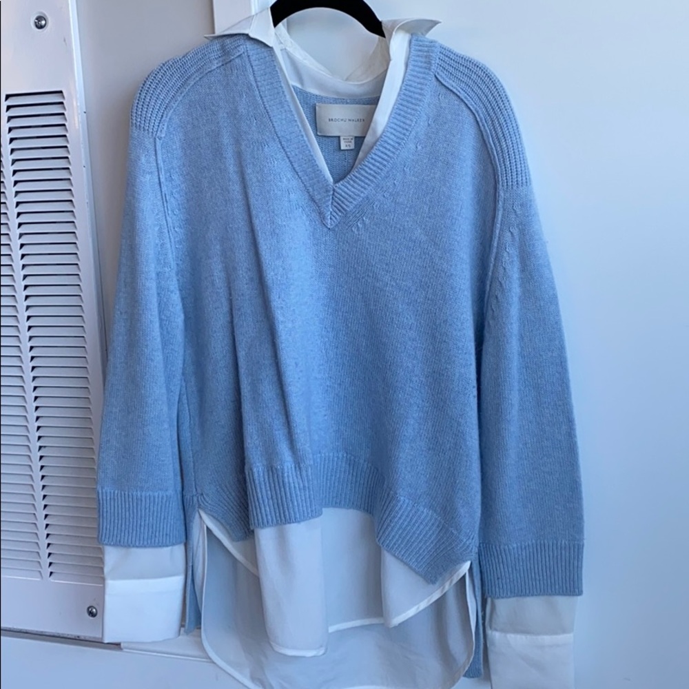 Blue sweater with a white button down attached.